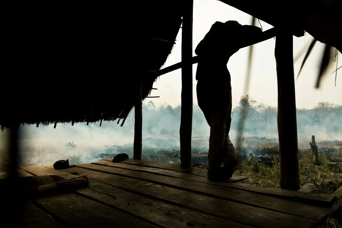 November 42, 2011 - Mondulkiri (Cambodia). A man controls the fire on his field. People in this village are indigenous but nowadays they seem to have lost most of their ancient traditions, as they have adopted many Western customs, such as the way they dress and, above all, the fact that they are now burning the forests that surround their village in order to plant potatoes and rubber trees. © Thomas Cristofoletti / Ruom