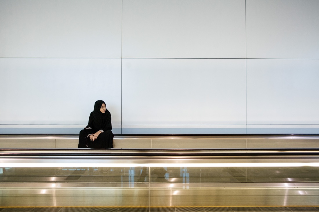  July 3, 2012 - Dubai (UAE). A girl sits on a moving walkway inside Dubai’s international airport. © Thomas Cristofoletti / Ruom 