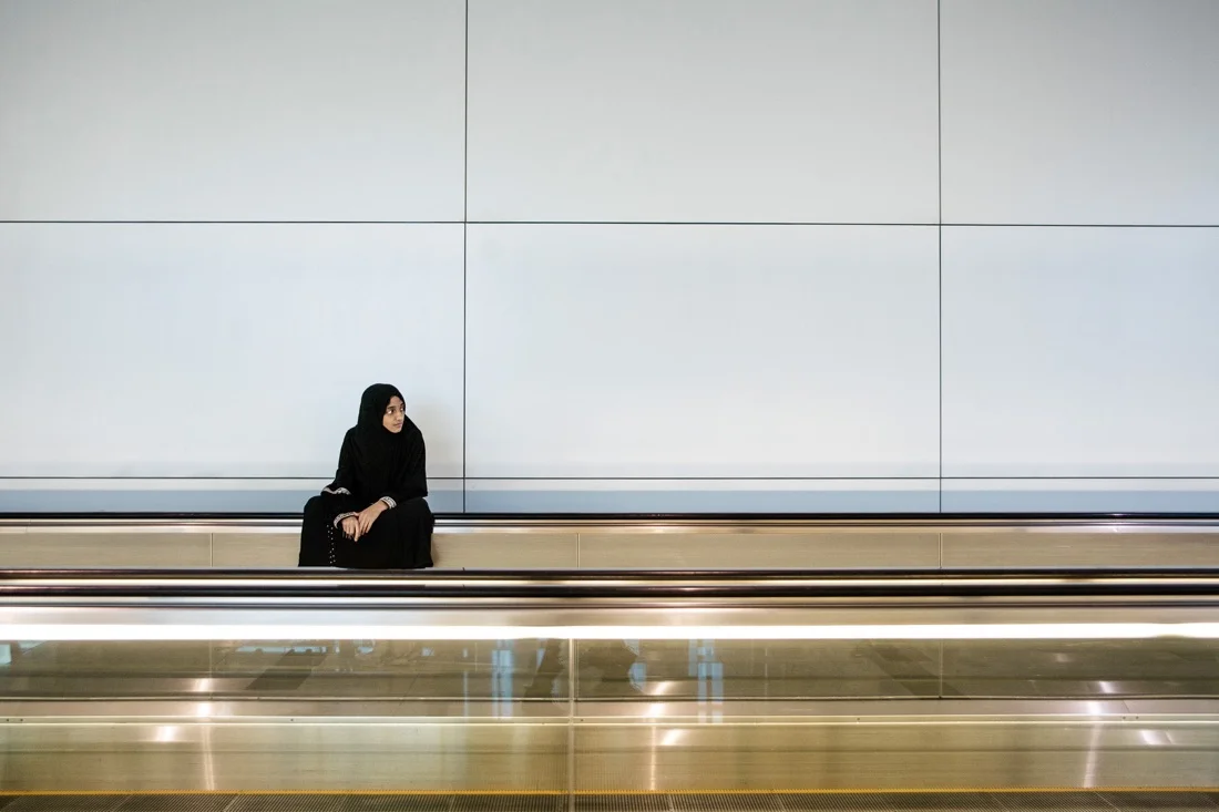 July 3, 2012 - Dubai (UAE). A girl sits on a moving walkway inside Dubai’s international airport. © Thomas Cristofoletti / Ruom