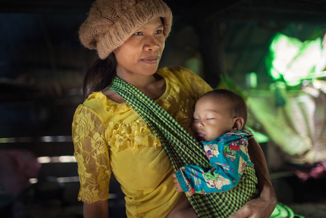  July 29, 2014 - Mondulkiri (Cambodia). A Phnong mother with her baby pose inside a traditional house in Busra village. © Thomas Cristofoletti / Ruom 