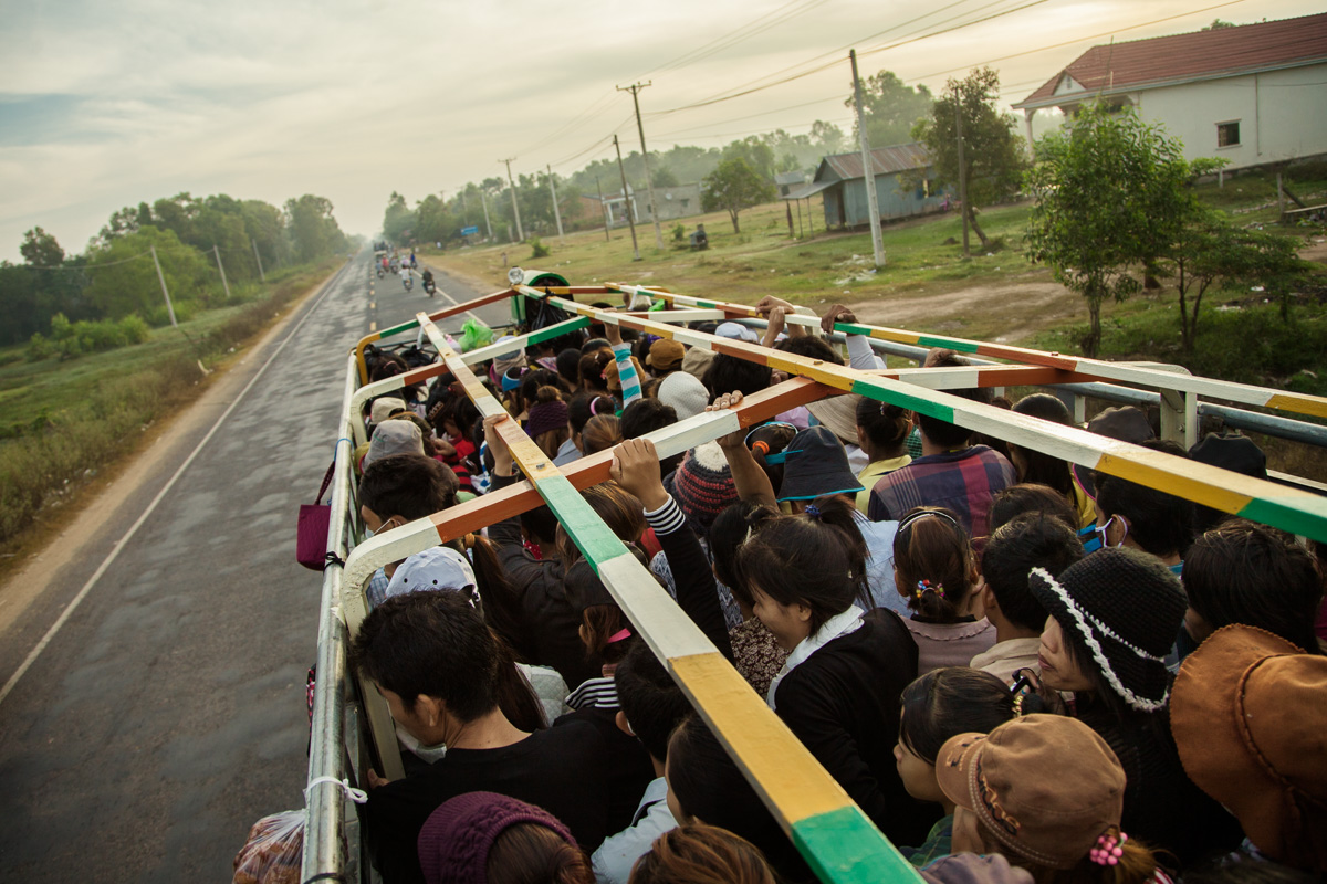 December 20, 2012 - Svay Rieng (Cambodia). A group of young factory workers is transported on a truck to the PUMA's shoes factory in Svay Rieng Province, on the border between Cambodia and Vietnam. The Cambodian energy sector needs considerable development if it is to meet the growing needs of the country and provide a stable and affordable power supply to potential investors in industry. The government sees hydropower as a priority area for development in the energy sector. © Thomas Cristofoletti / Ruom
