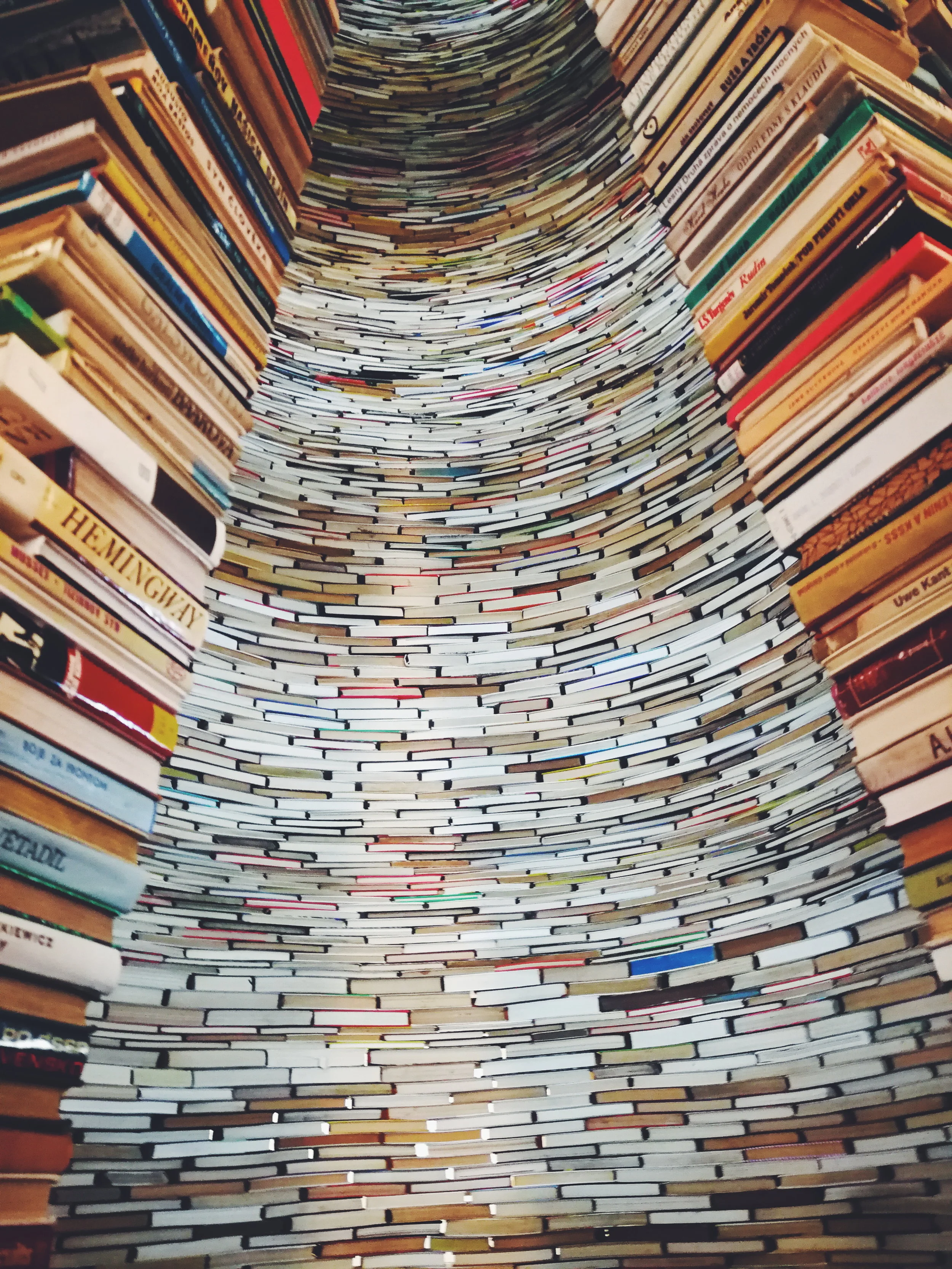 a large stack of books in a circular formation