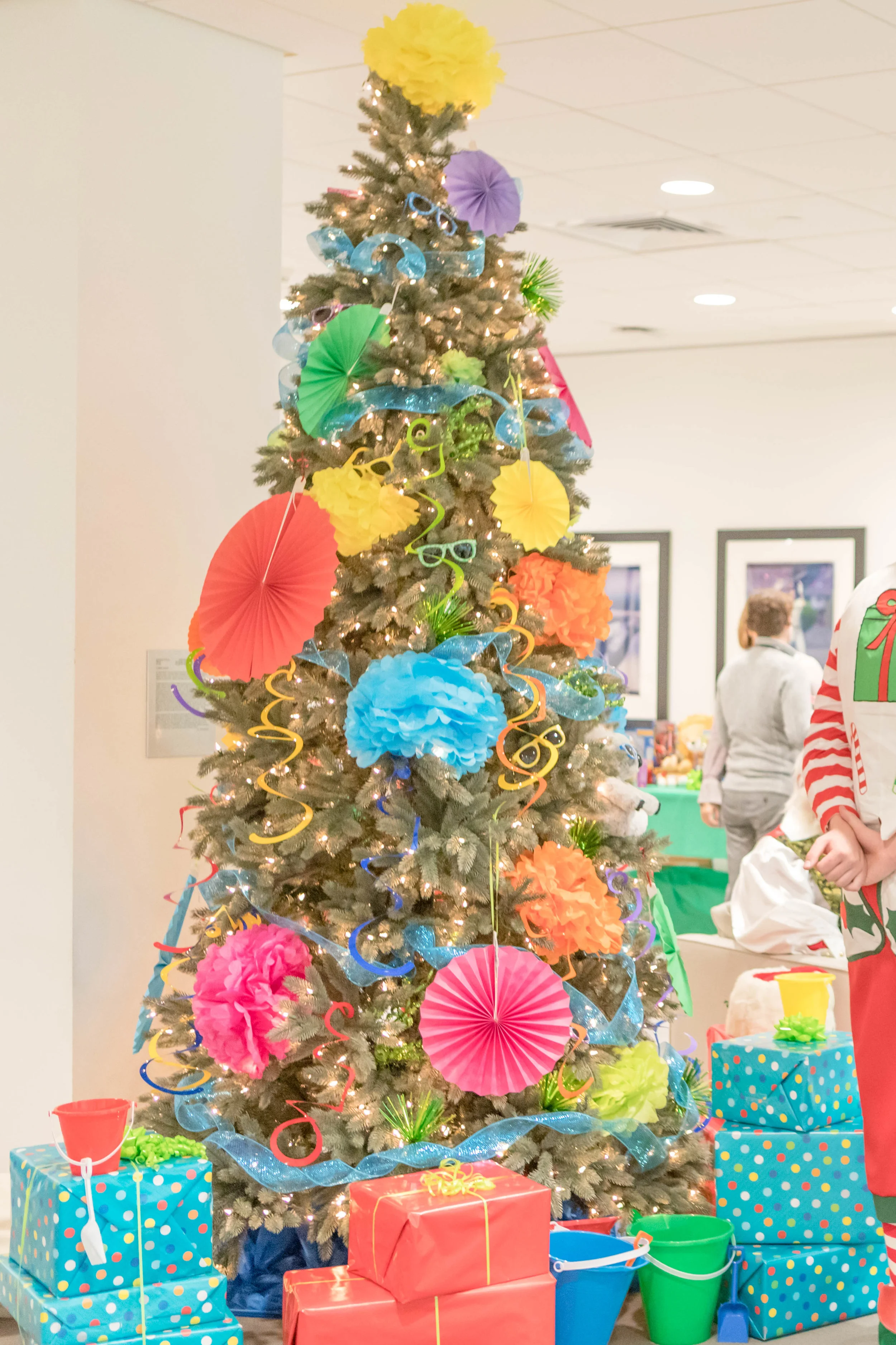 Who said summer & Christmas don’t mix! Our summer fun tree, decked out in all the seasons finest, most fun colors. This 9ft. blue spruce was gifted by Tree Classics .