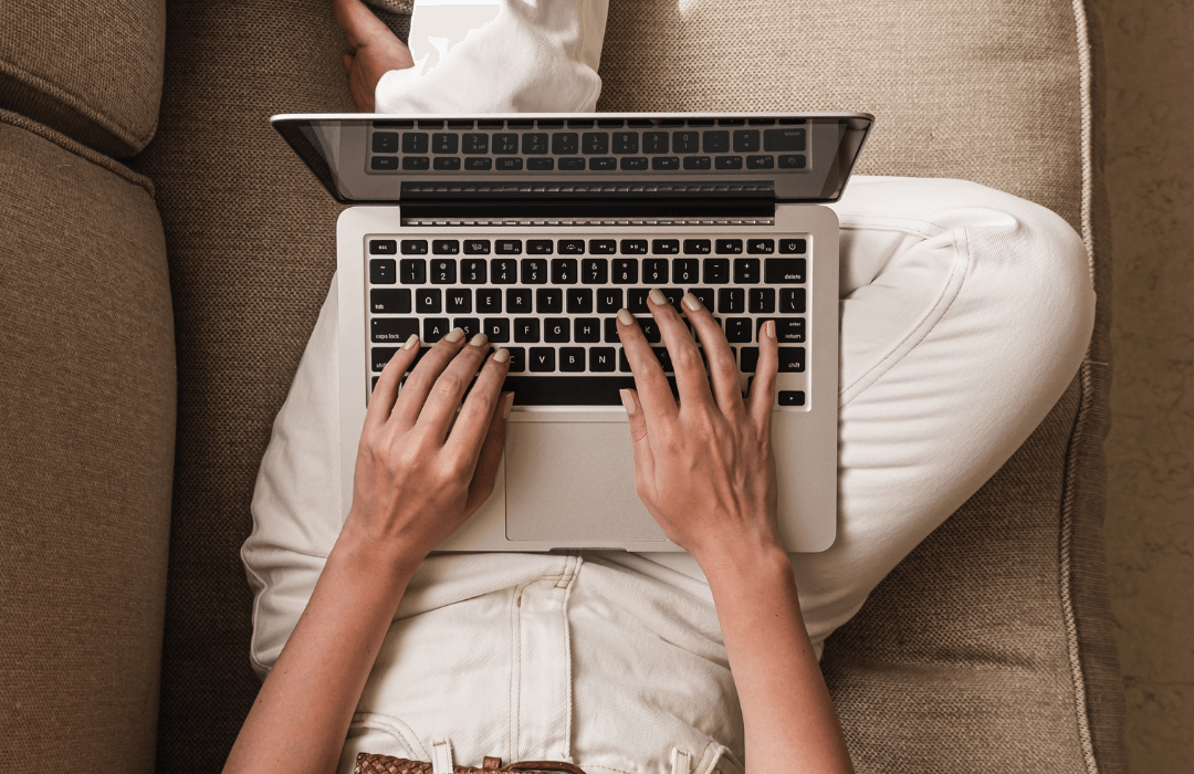 Woman using a laptop to book a free call for home organizing support.