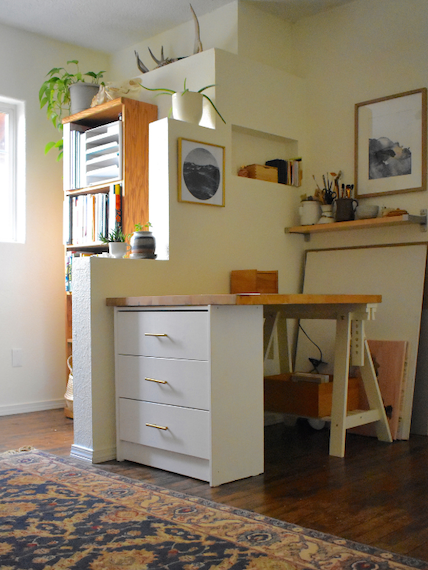 Organized art studio with thoughtfully arranged supplies in a calm, creative workspace.