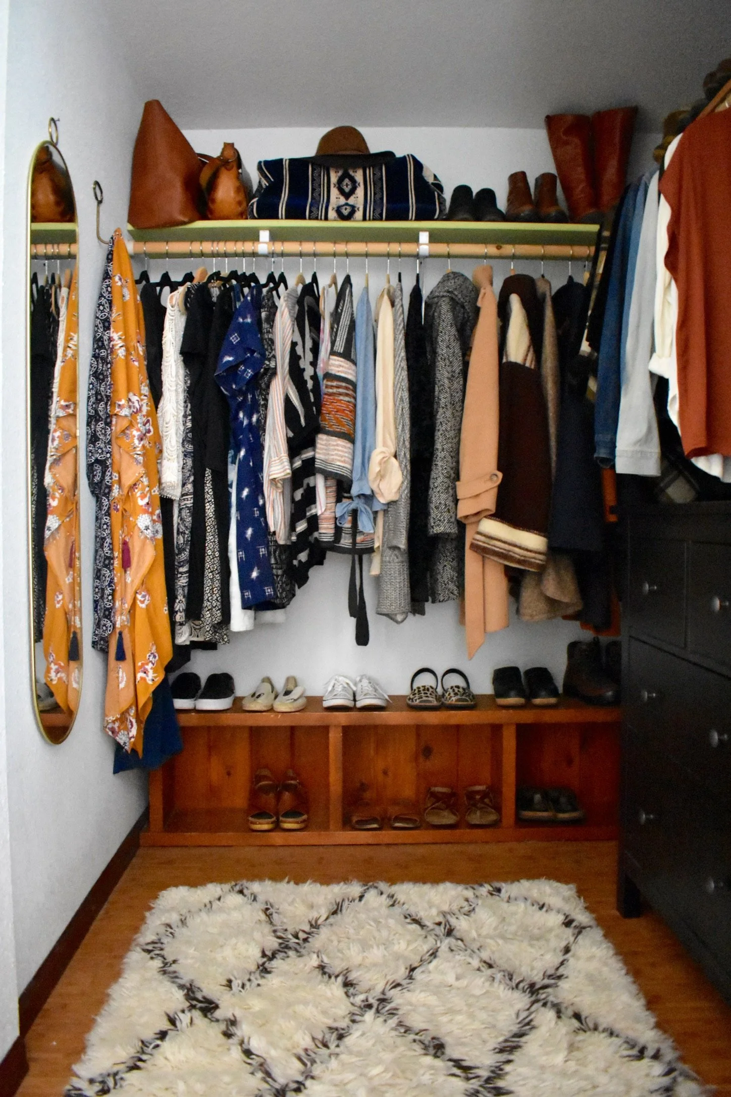 Organized women’s closet with simplified storage that makes getting dressed feel easy.