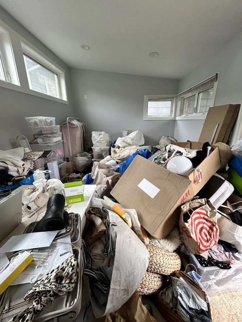 Cluttered home office with papers and items piled up before decluttering and organizing.