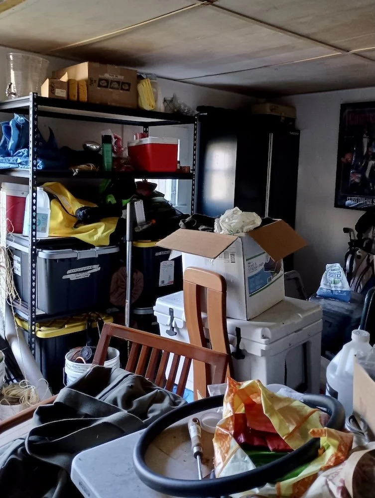 Messy, cluttered garage before decluttering and organizing support.