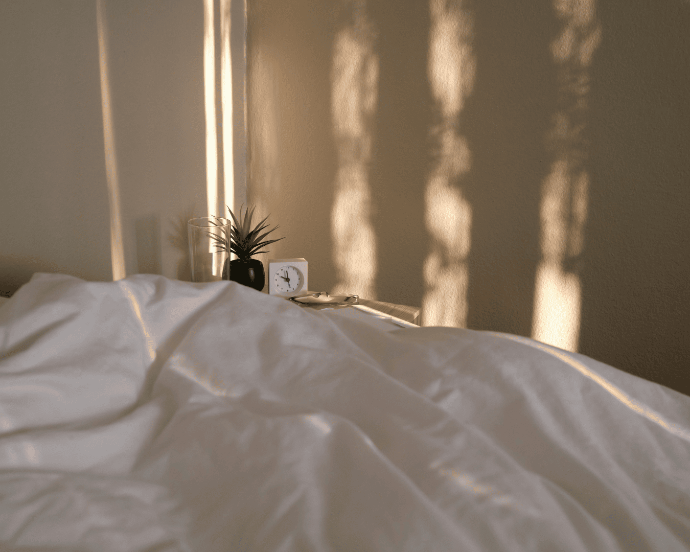 Comfortable, well-layered bedding making a rental bedroom feel cozy and restful.