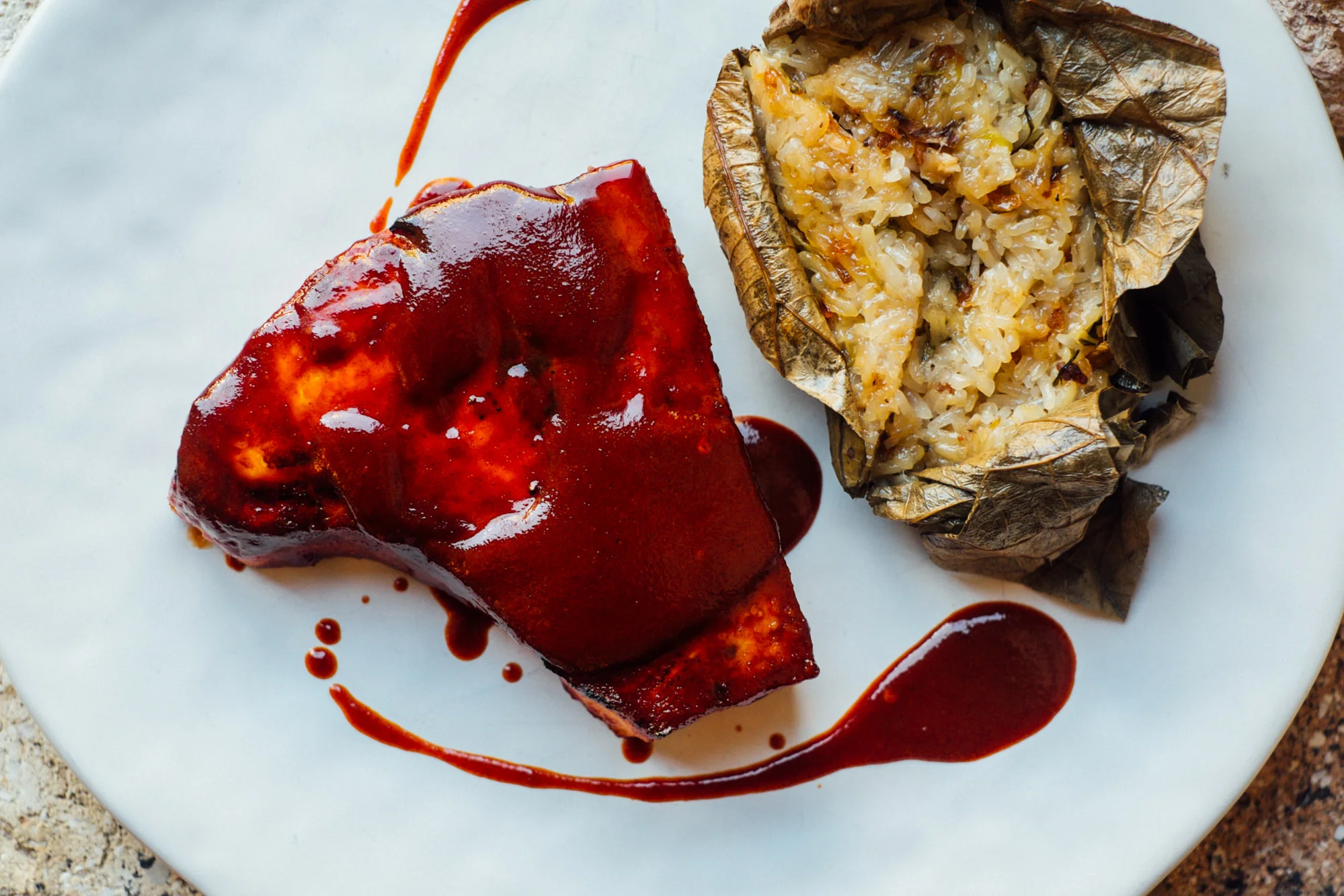 Cha Siu Glazed Swordfish Steak with Lo Mai Gai (sticky rice wrapped in a lotus leaf).