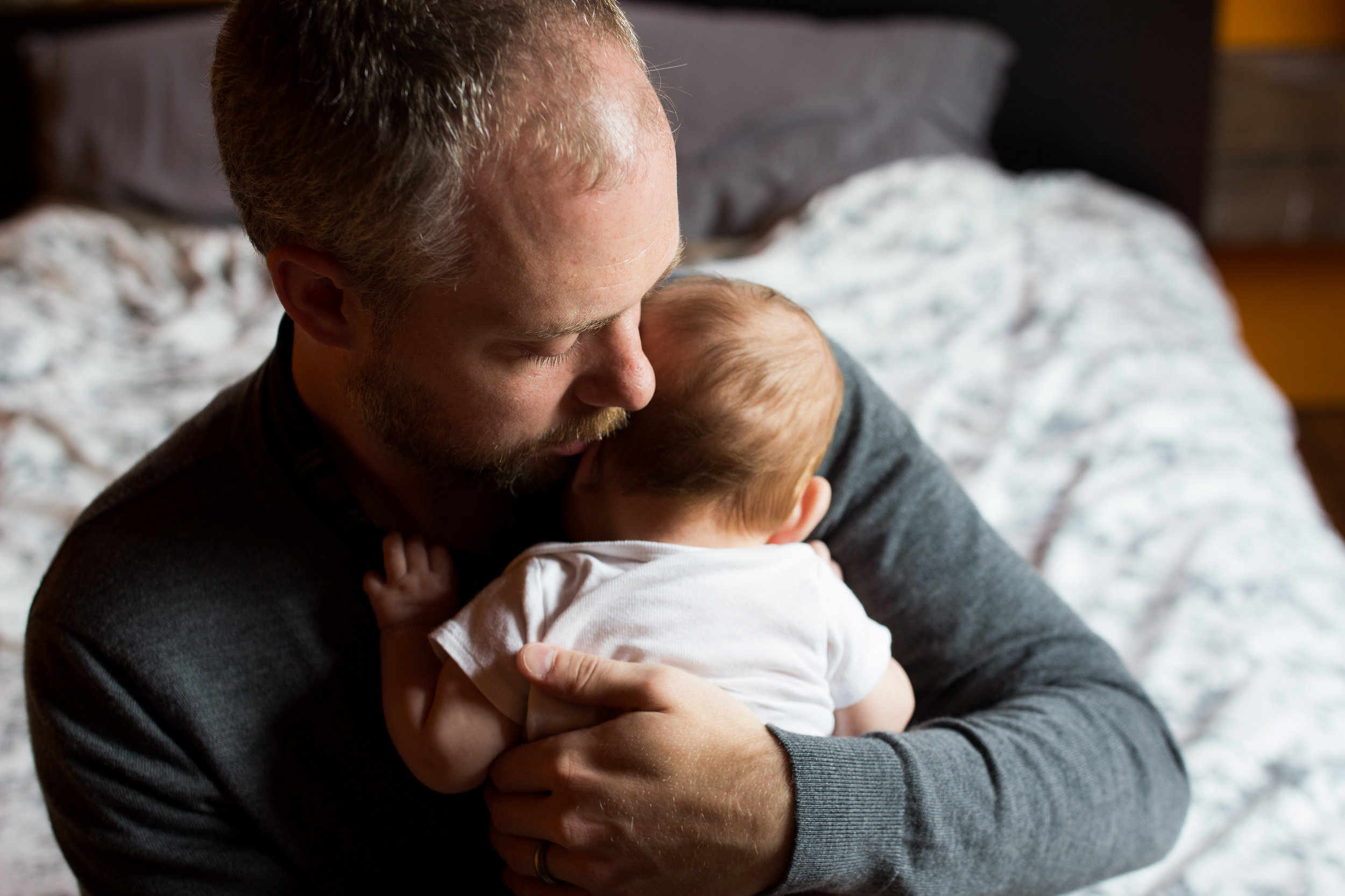 Dad holding newborn baby  | Jaime Bugbee Photography
