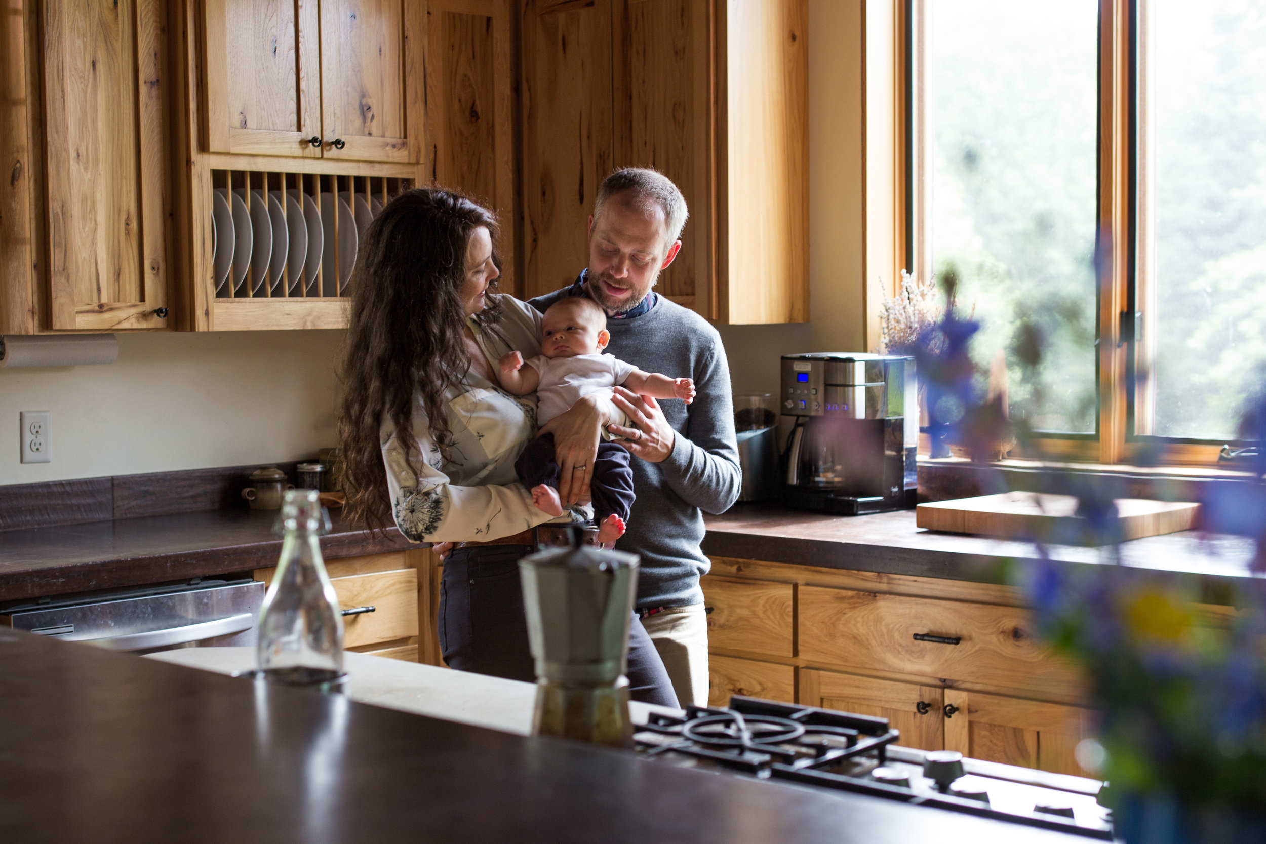 Newborn held by parents | Jaime Bugbee Photography