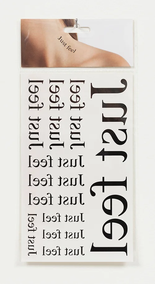Just feel , 2014, removeable tattoo, c-type print on cardboard and cellophane.