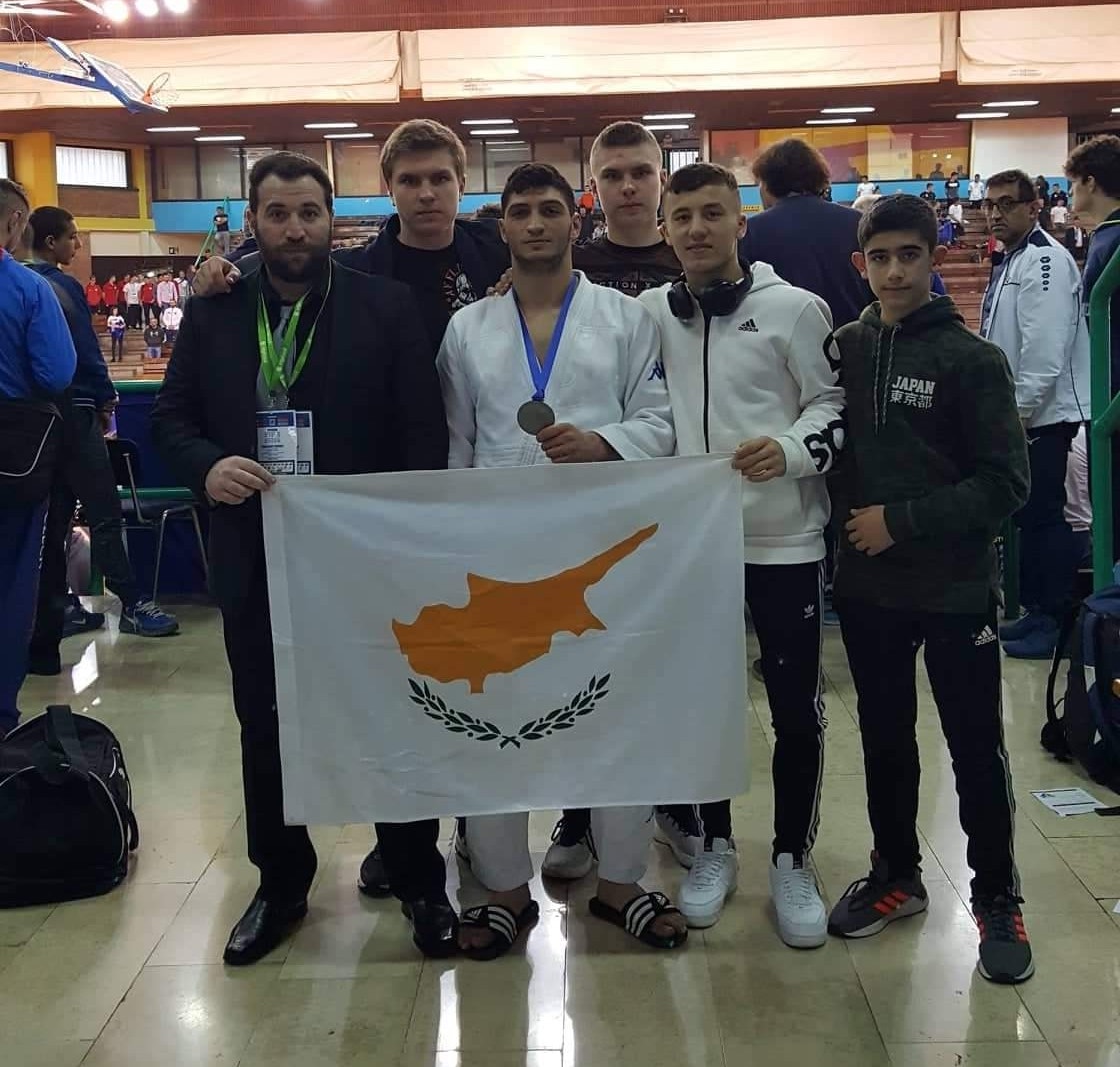 Silver medalist Panagiotis Shakkos pictured with coach Marinos Piponas and other members of the team proudly flying the Cypriot flag 