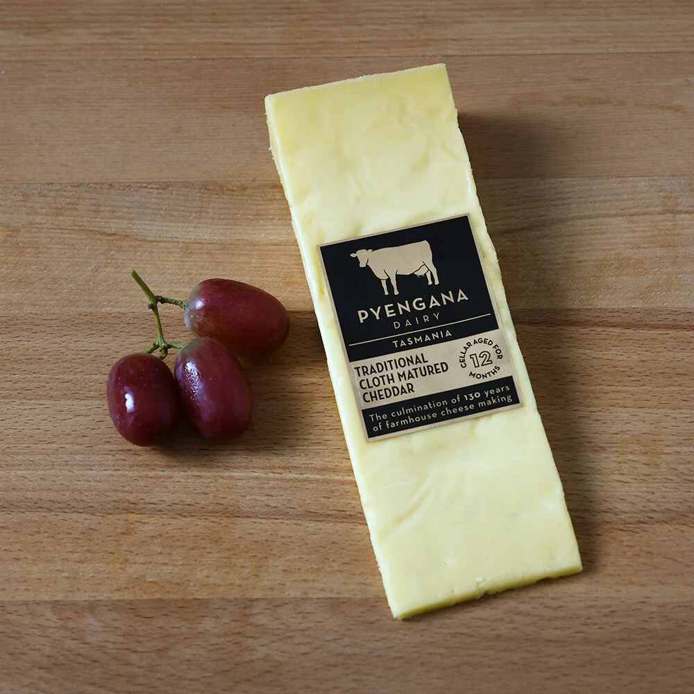 5_pyengana_dairy_traditional_cloth_matured_cheddar_packshot_with_grapes.jpg