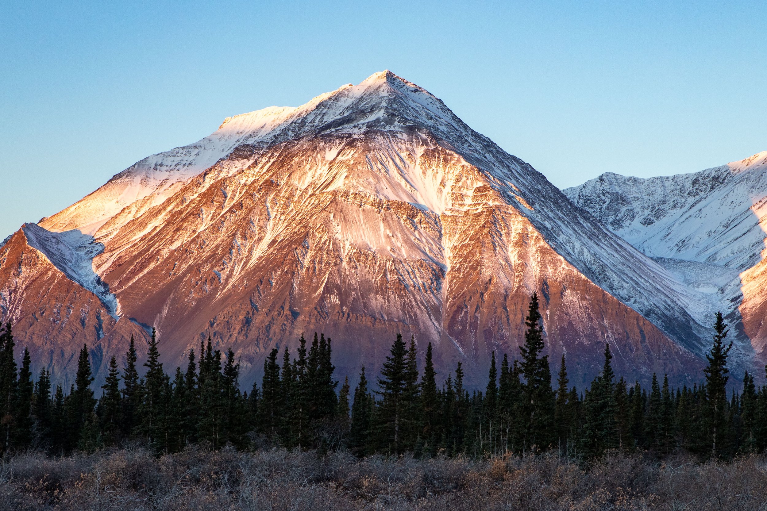 A sunrise lights the mountains near Kluane National Park.