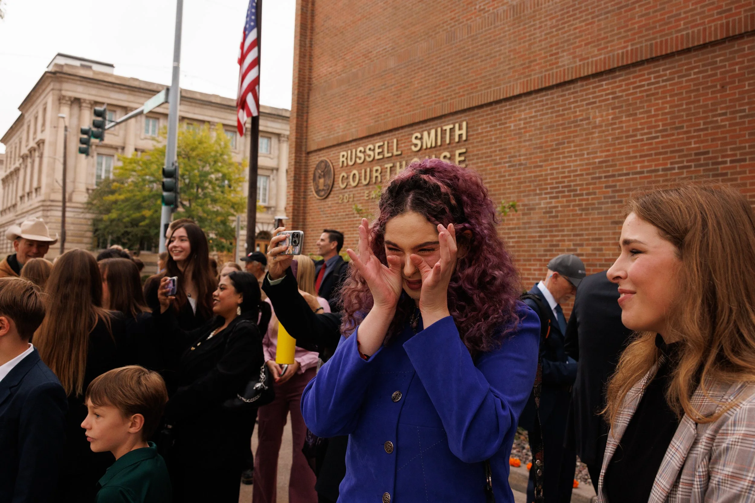 Youth plaintiffs Olivia Vesovich, 22, and Georgi, 23, respond to supporters encouragement outside the Russell Smith Courthouse in Missoula, Montana on Tuesday, September 16, 2025. 