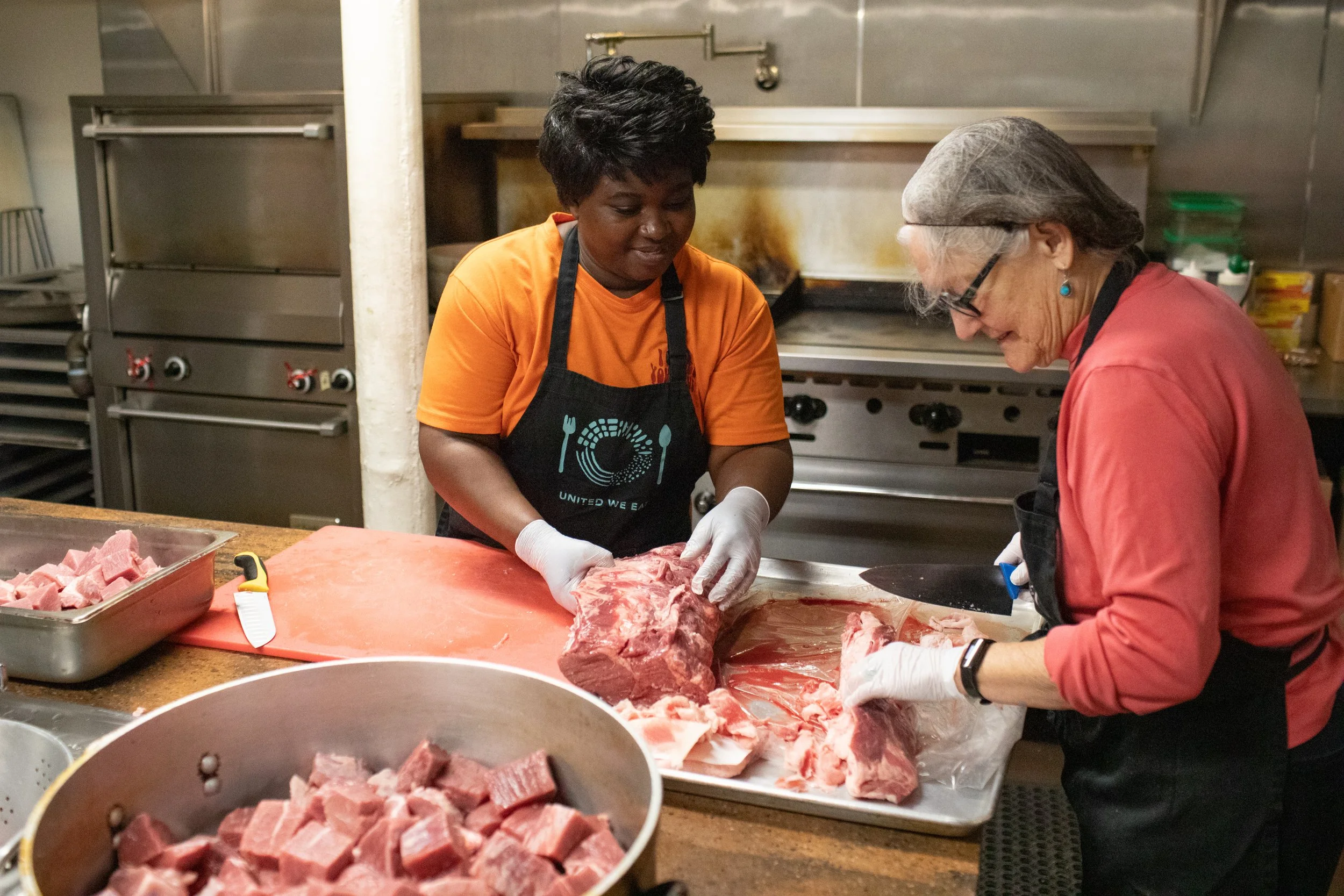 Chef Grace Mussiwa, a refugee from the Democratic Republic of the Congo, prepares Beef a la Tomate with volunteers for the United We Eat program at the First Methodist Church in Missoula, Montana on Monday, March 11, 2024. United We Eat uses food as 