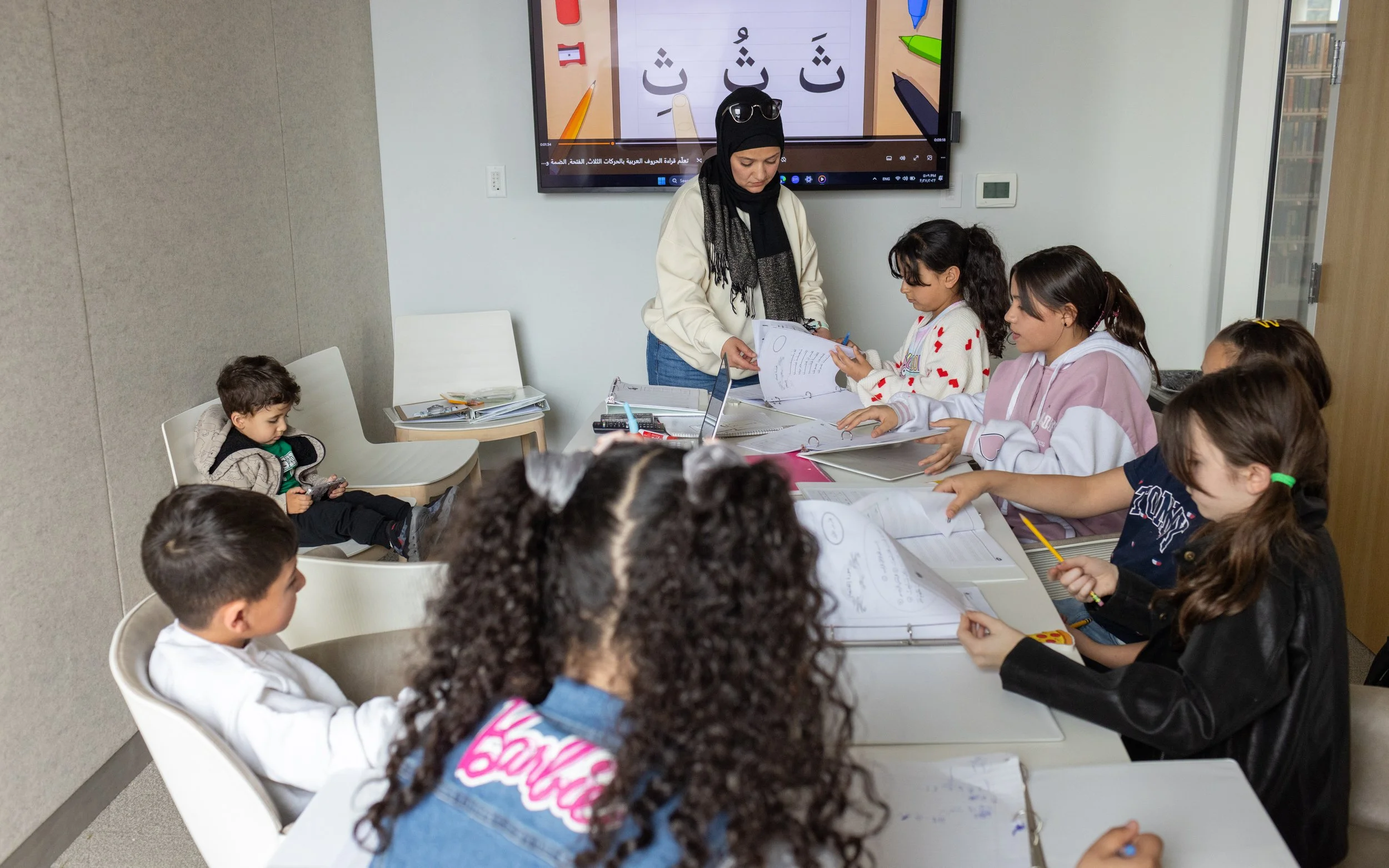  Kamar Mardelli, a Syrian refugee, practices pronunciations with her students from the resettlement community at the Missoula Public Library on Sunday, April 27, 2024. Many of the kids are fluent in English, but some have partially forgotten how to s