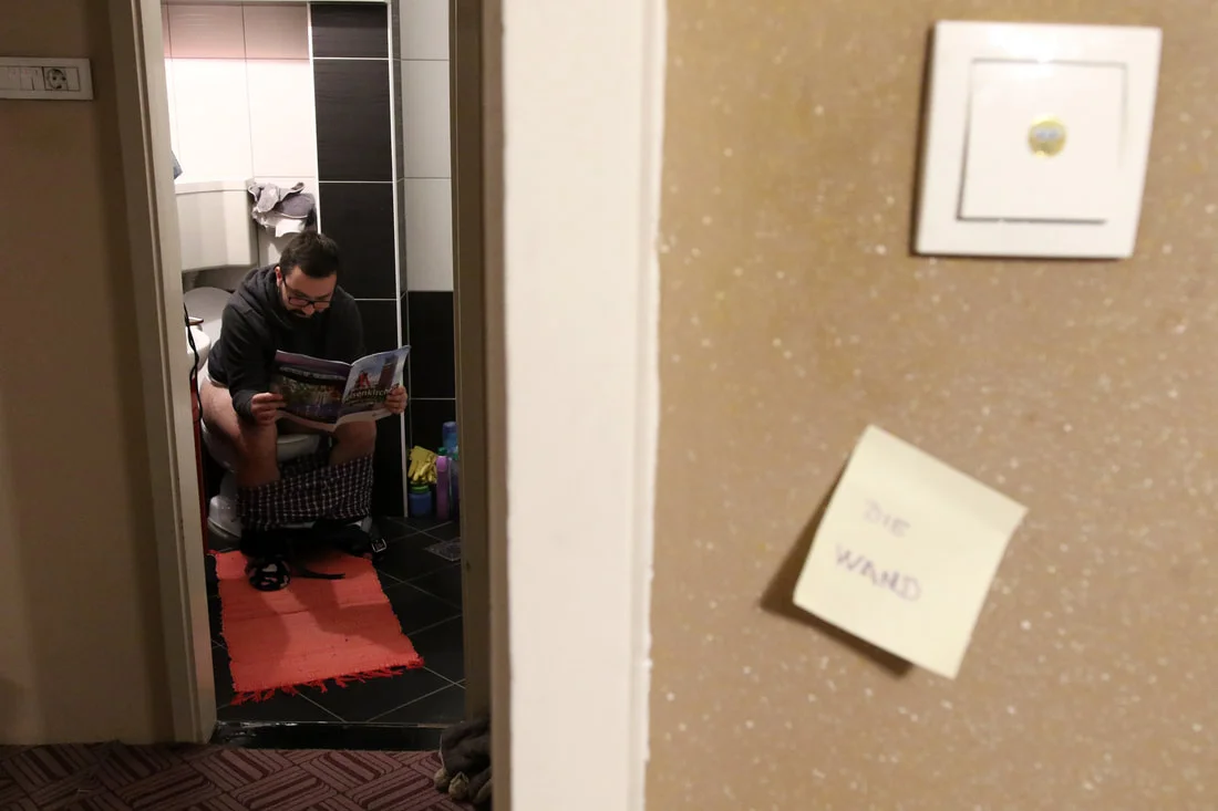 March 27, 2017, Zenica - Alen Marijanovic is seen reading a brochure "Welcome to Gelsenkirchen." It's said, that roughly 100,000 people have left Bosnia, in search of a better life.