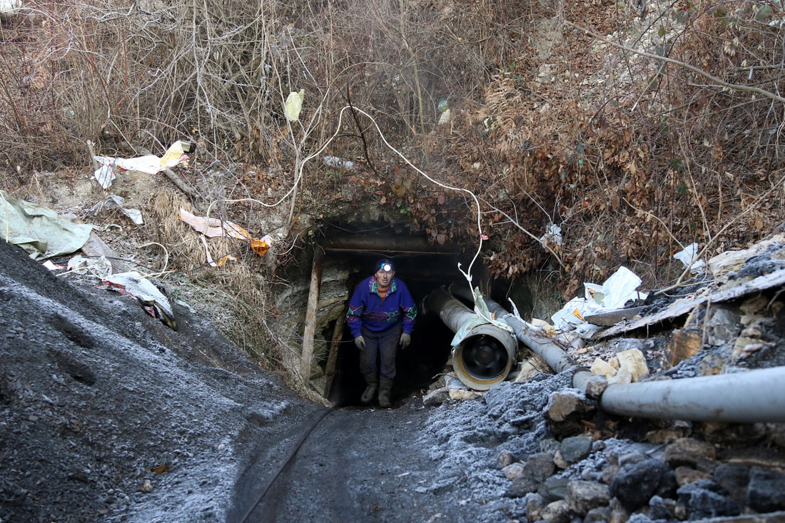 December 11, 2016, Kozarci - Illegal miners are seen exiting a mine. Miners work with makeshift tools and dig out coal from illegal mines earning 20KM a day, and digging out about 40 tons of coal.
