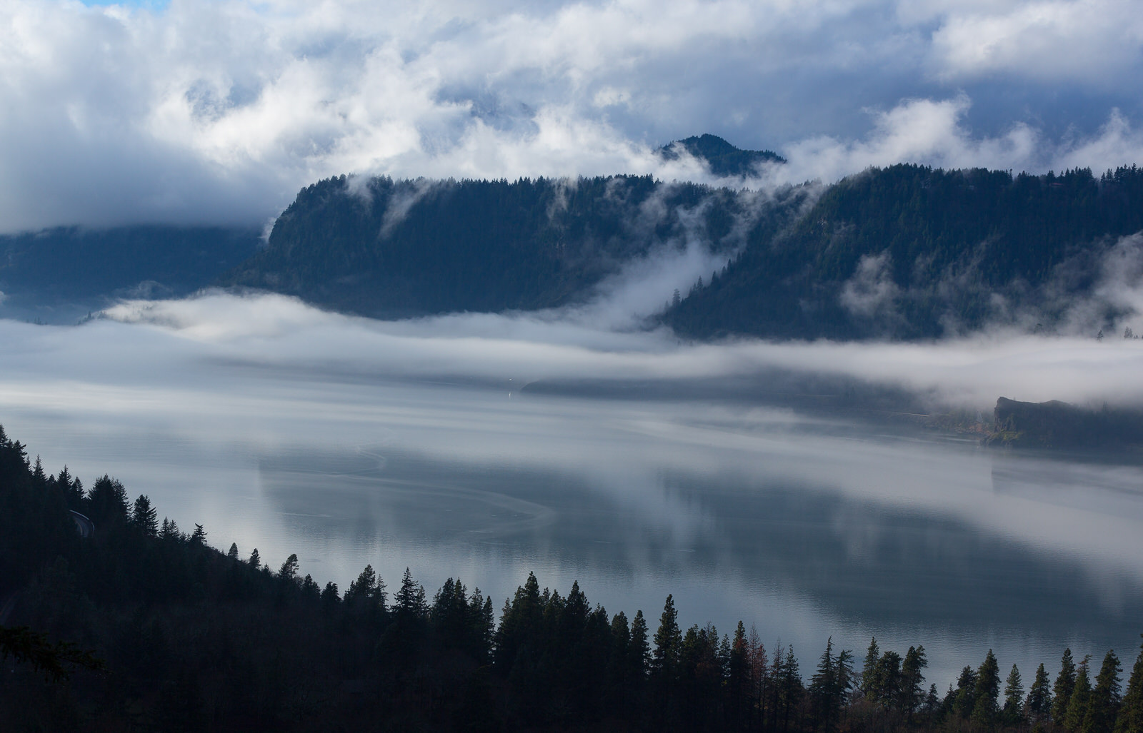  Fog flows over a calm Columbia River 