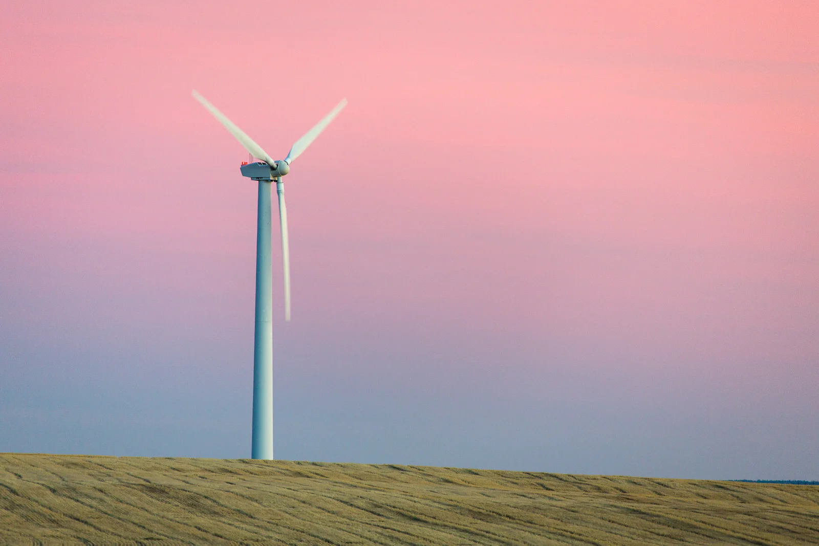 Lone wind turbine in a wheat field at dusk near Wasco, Oregon