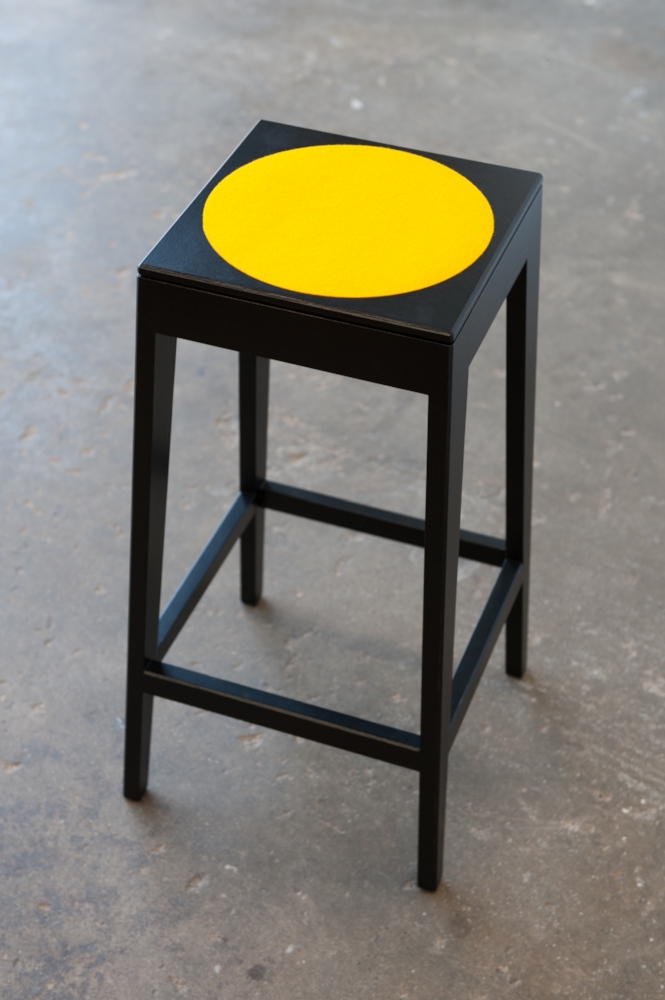 Black Breakfast Bar Stool with Yellow Felt circular inlay.