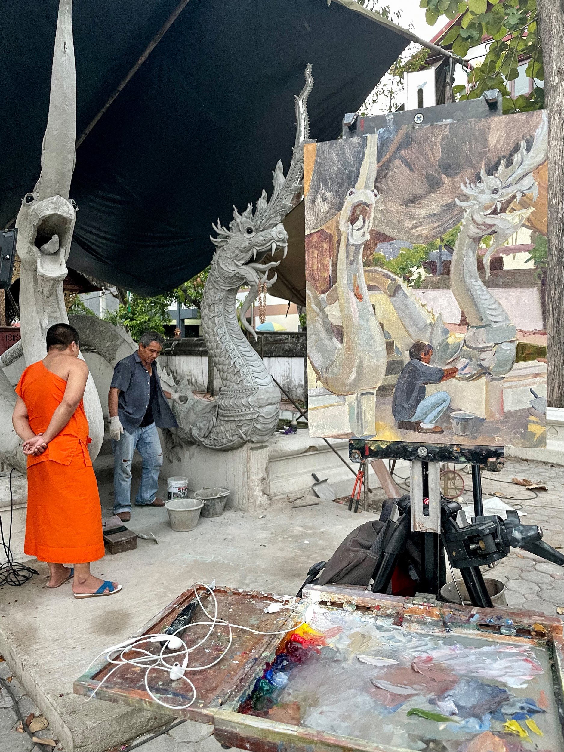 Progress as a monk from the temple checks out Narong's work