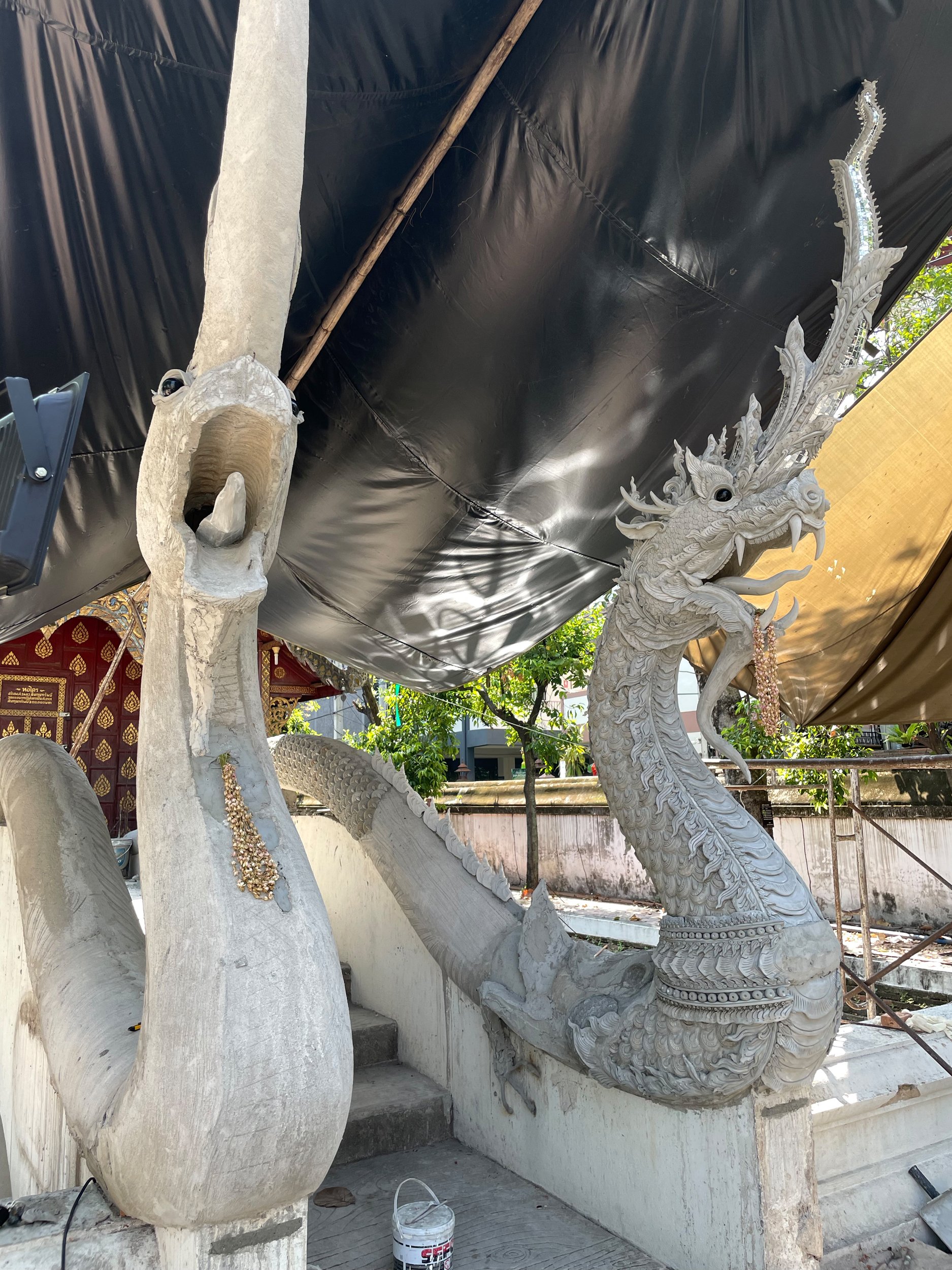 Finding my subject, an elaborate concrete Naga sculpture in progress at the temple of Wat Chiang Man