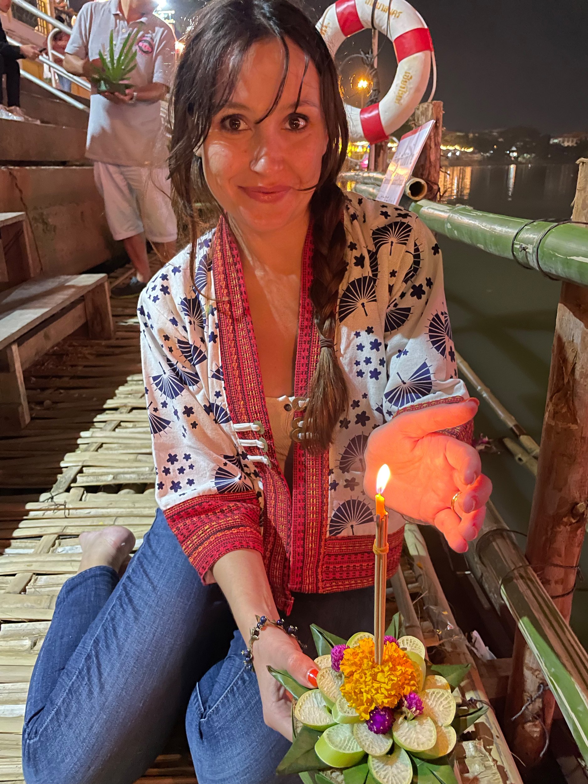 Marta preparing to launch her floating lantern (Krathong) into the river