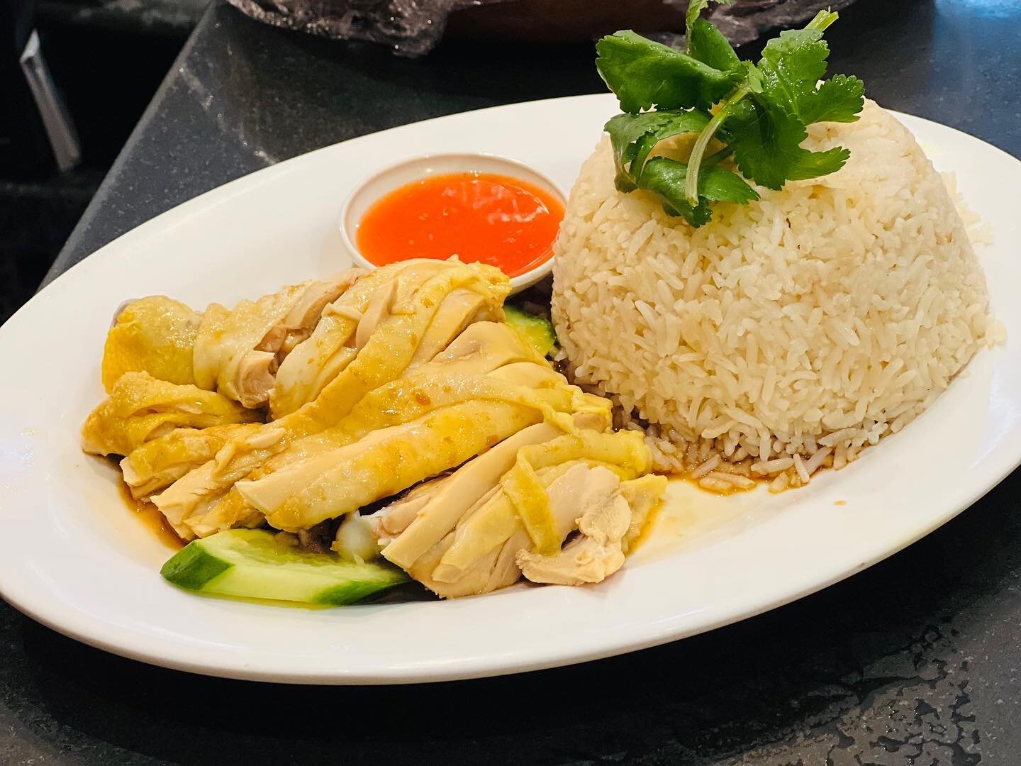 Hainanese Chicken Rice. 
Are you Team Drumstick Thigh 🍗 or Team Breast? 🐓
Poached chicken served on a bed of cucumber with a side of fragrant rice.
(45 on the menu)
