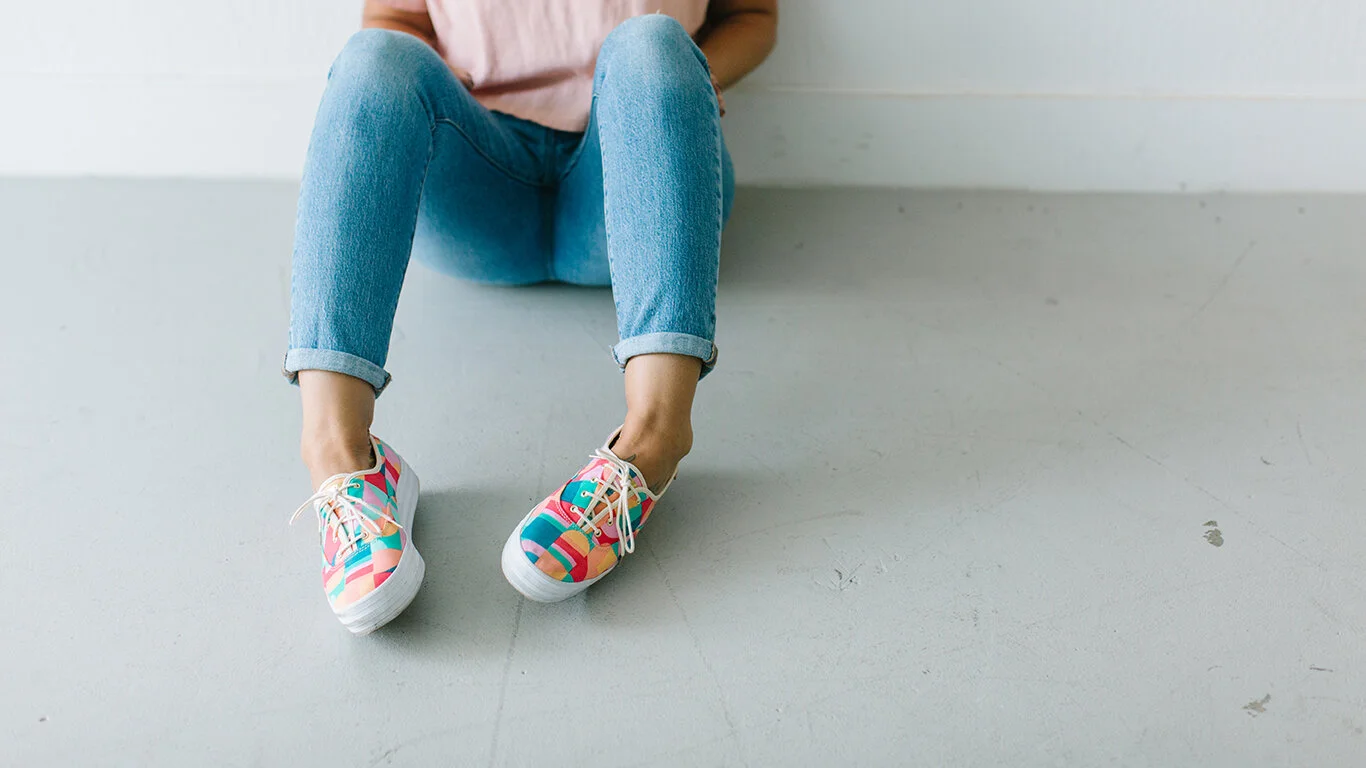 livermore-handlettering-artist-sitting-on-concrete-floor-with-multi-colored-keds.jpg