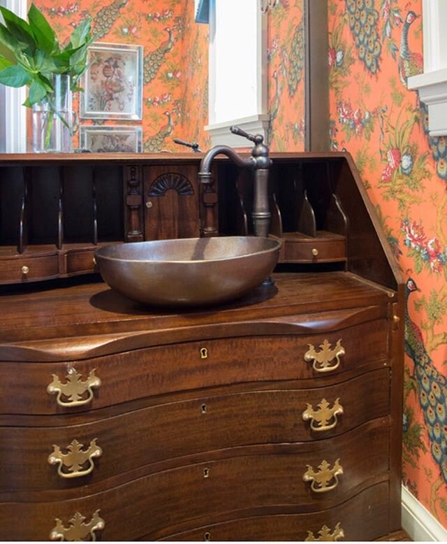 A small secretary was reimagined, reworked and retrofit it into a unique vanity for a powder room.