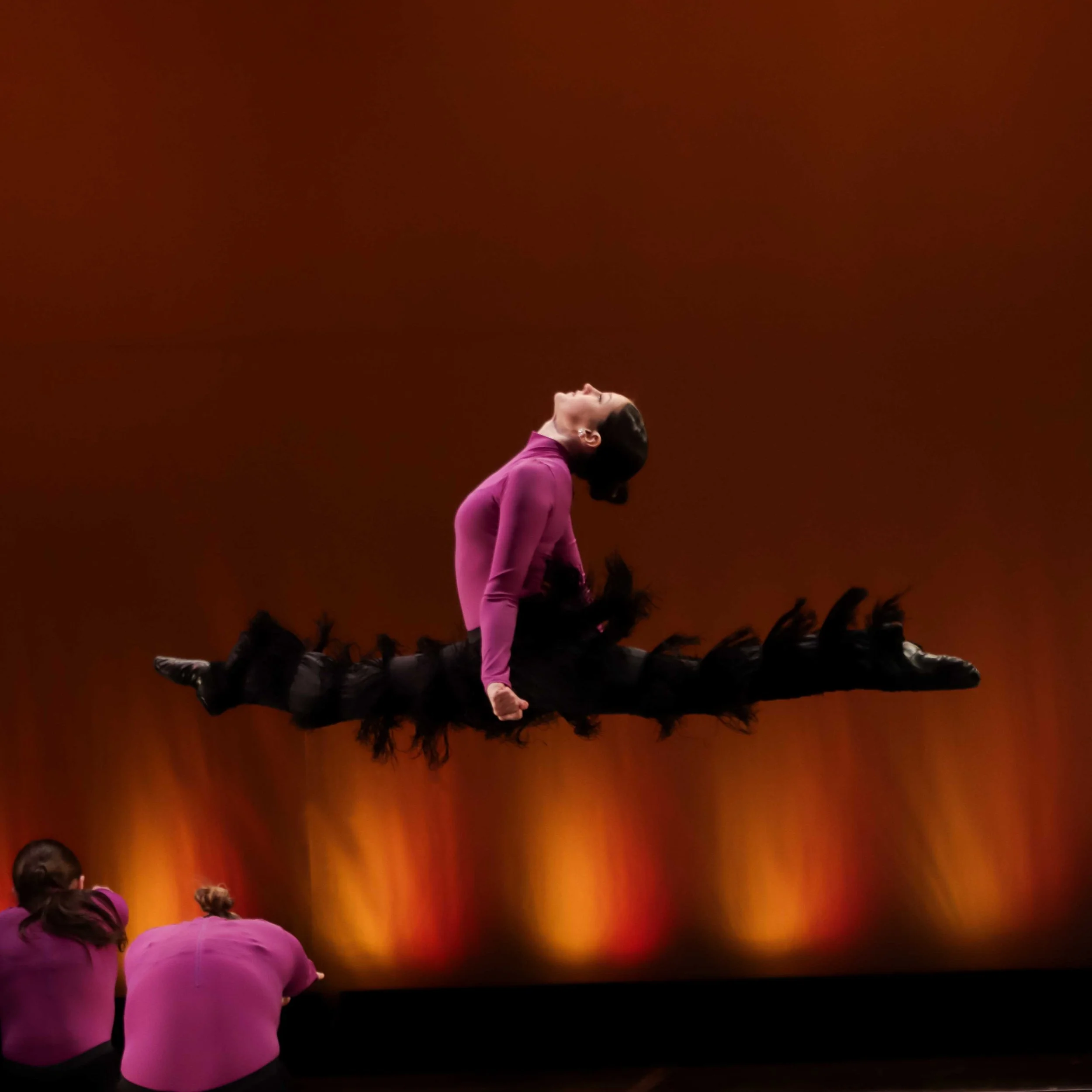 photograph of a dancer mid leap during a dance performance