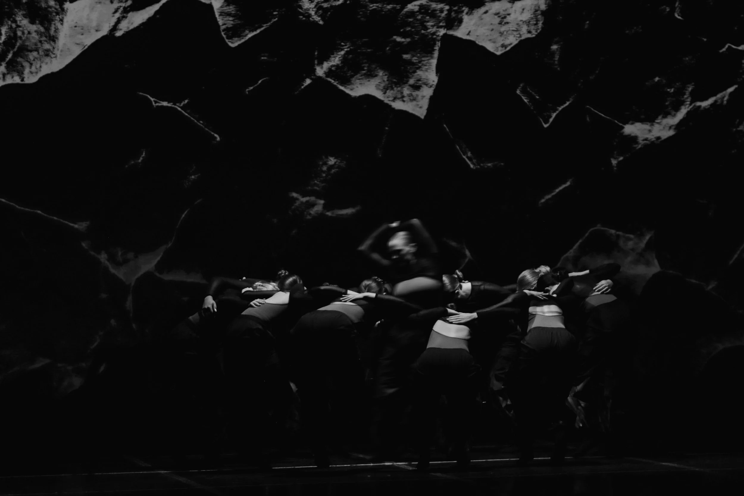 Contemporary dance performance on stage in black and white