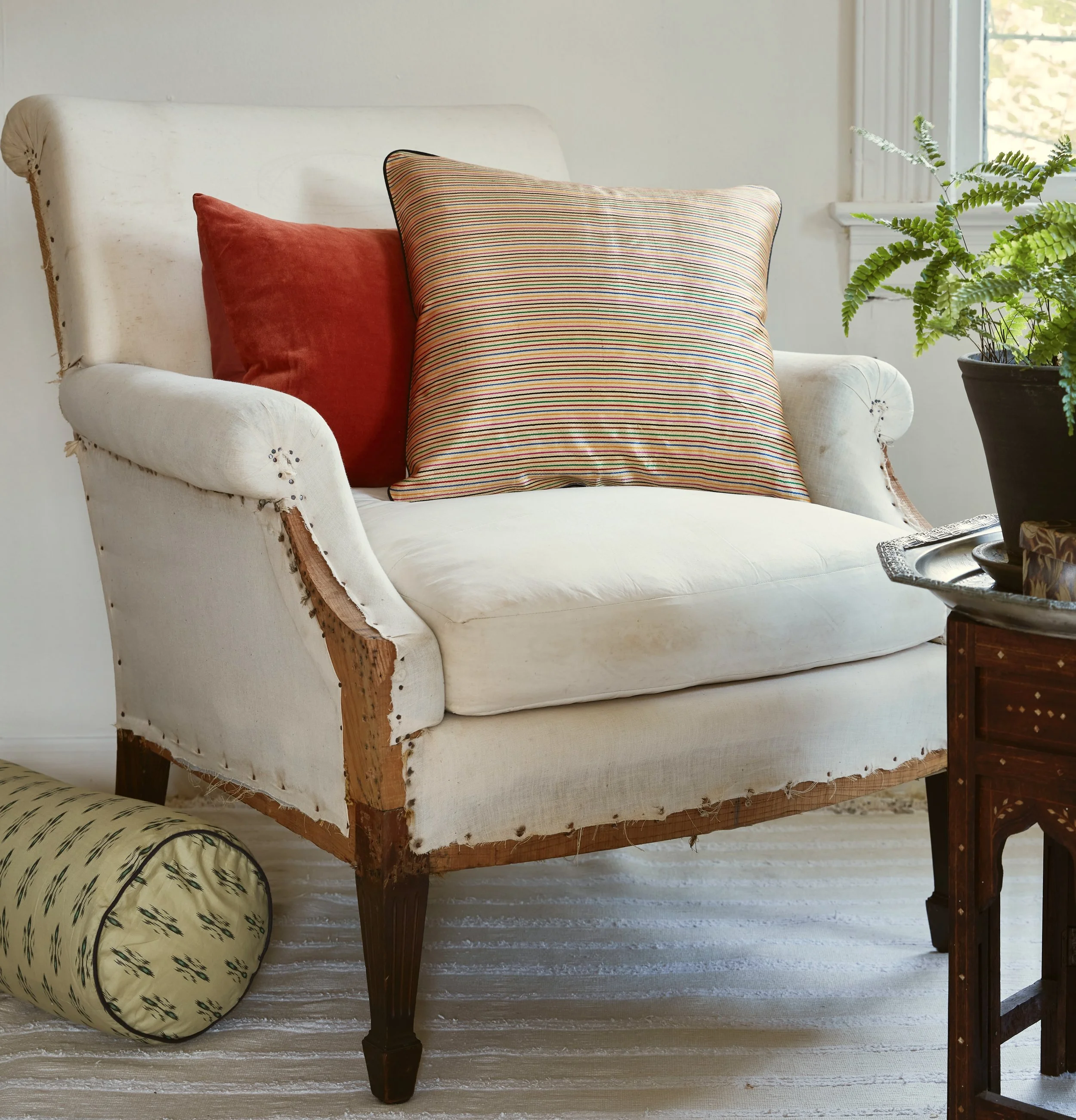 Pillows assortment, gold stripe, burnt orange velvet, & green bolster