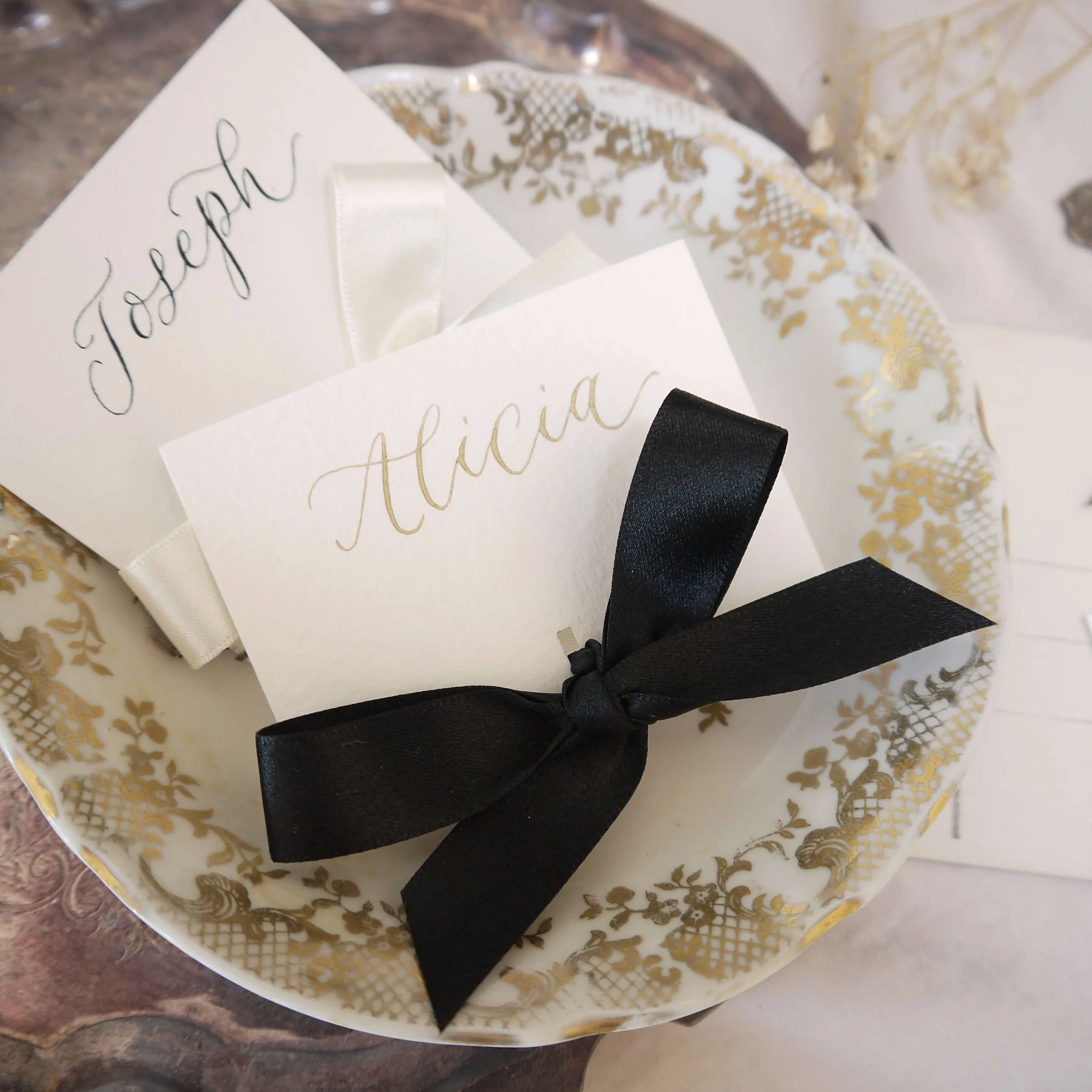 Name card for a wedding with a satin tied bow