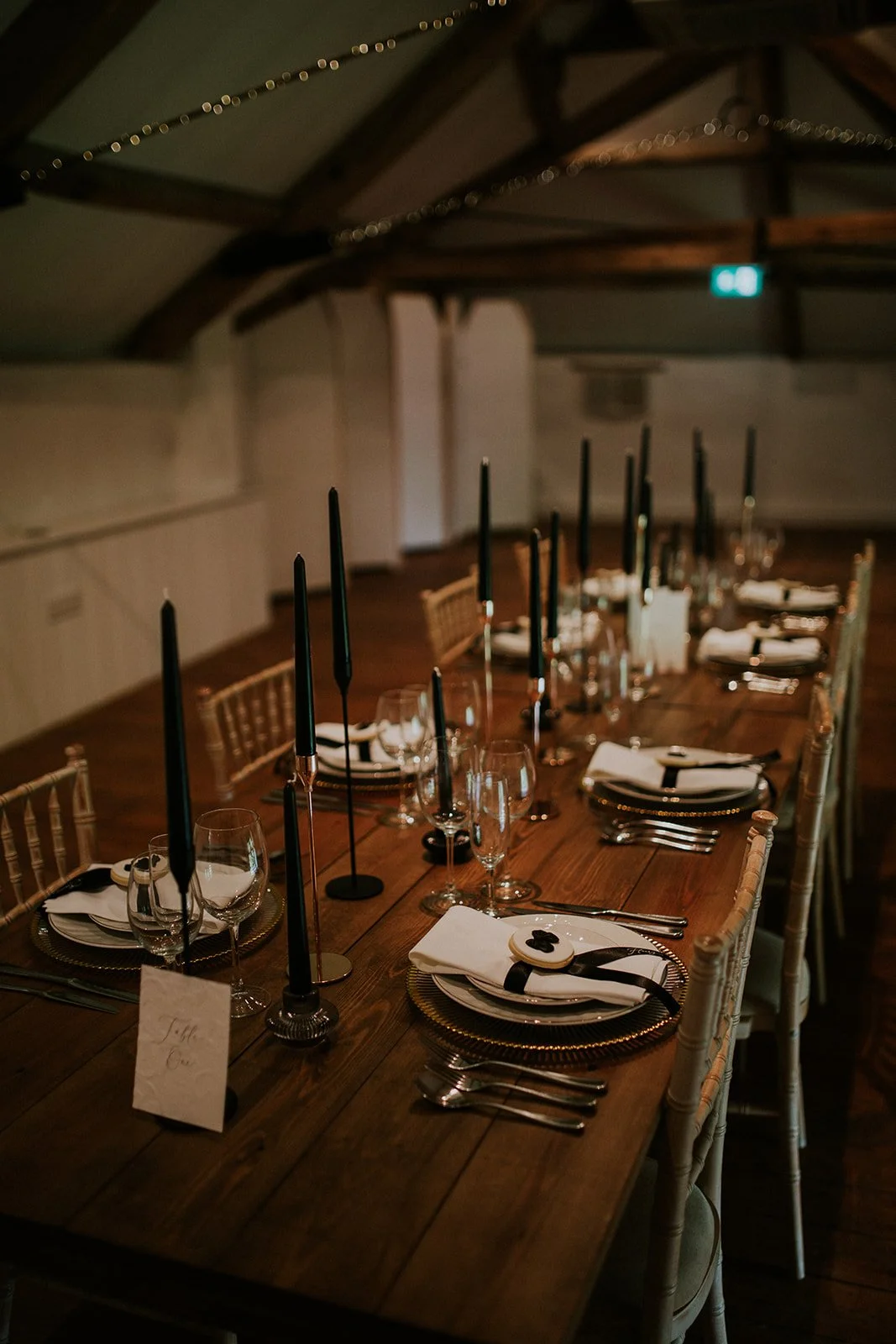 Classic monochrome wedding tablescape with candlelight and bespoke stationery