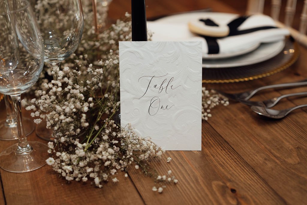 Embossed table number signage in black and white for timeless wedding décor