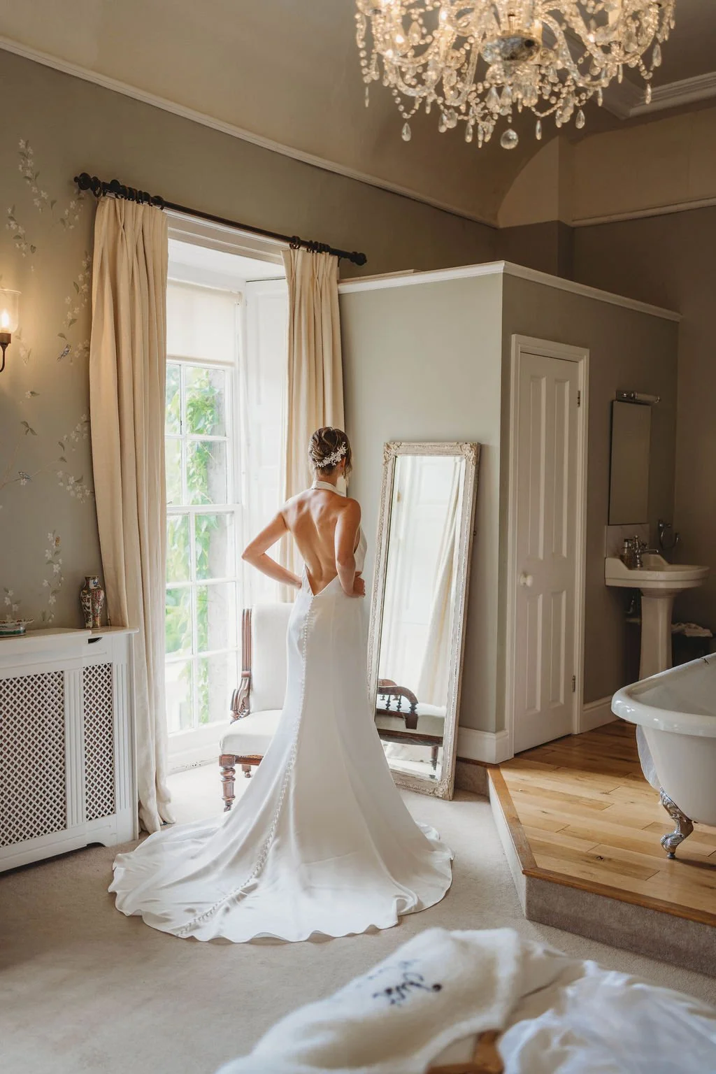 Candlelit country house wedding reception with soft florals and classic black and white palette