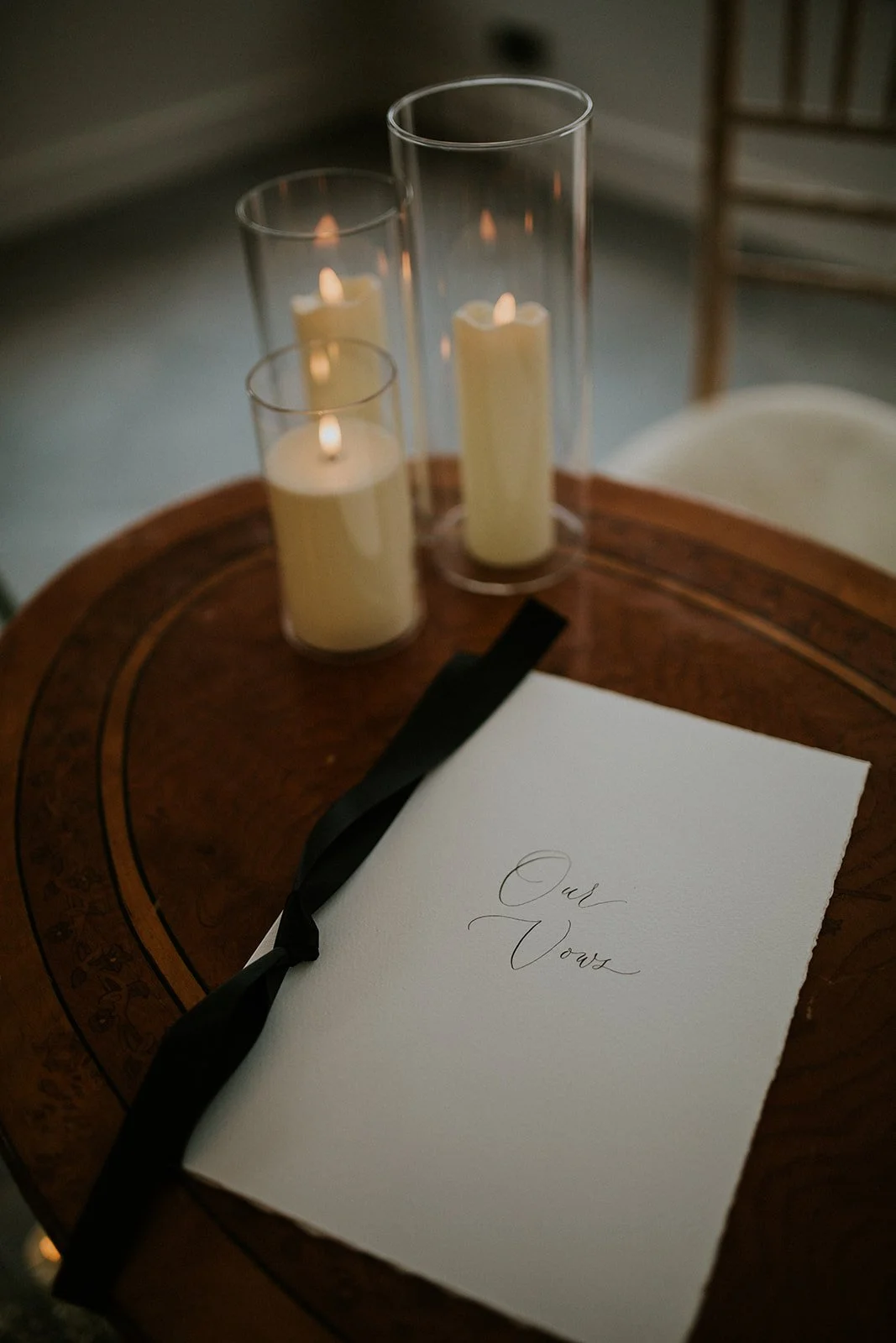 Handwritten wedding vow folder in flowing modern calligraphy for a formal reception