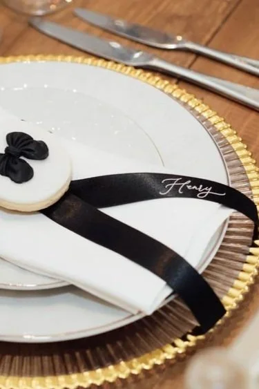 Silk ribbon place names with white calligraphy for wedding seating