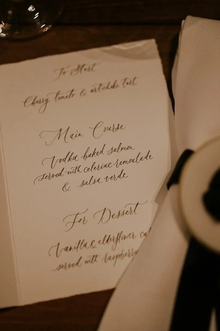 Handwritten wedding menu in flowing modern calligraphy for a formal reception