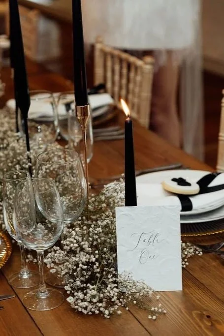 Embossed table number signage in refined monochrome palette