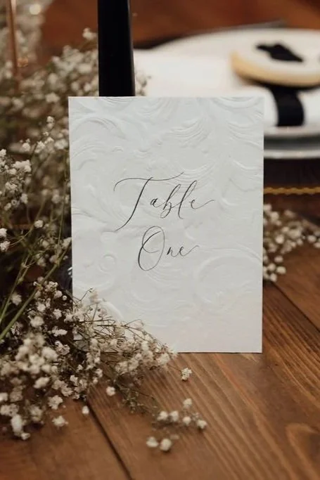 Embossed table number signage in black and white for timeless wedding décor
