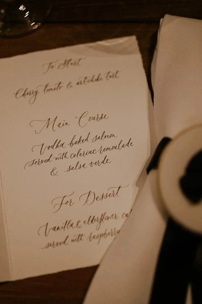 Handwritten wedding menu in flowing calligraphy script