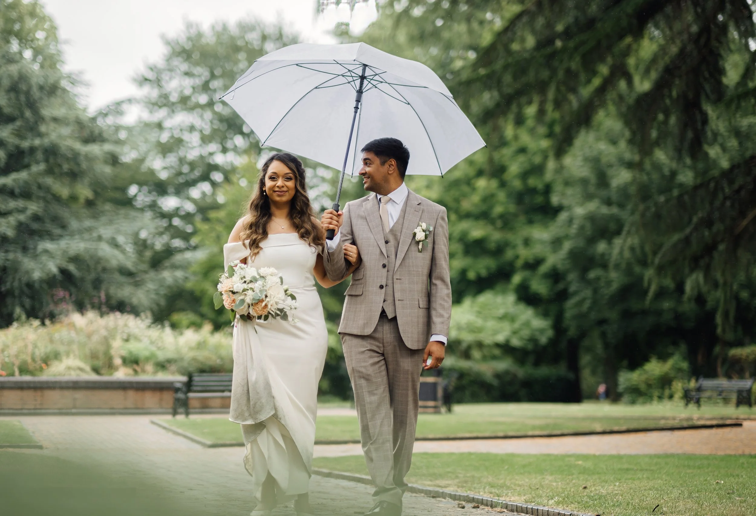 Bridgford-Hall-Wedding-Photography-83.jpgRiddhi and Vivek walking together in the rain at Bridgford Hall