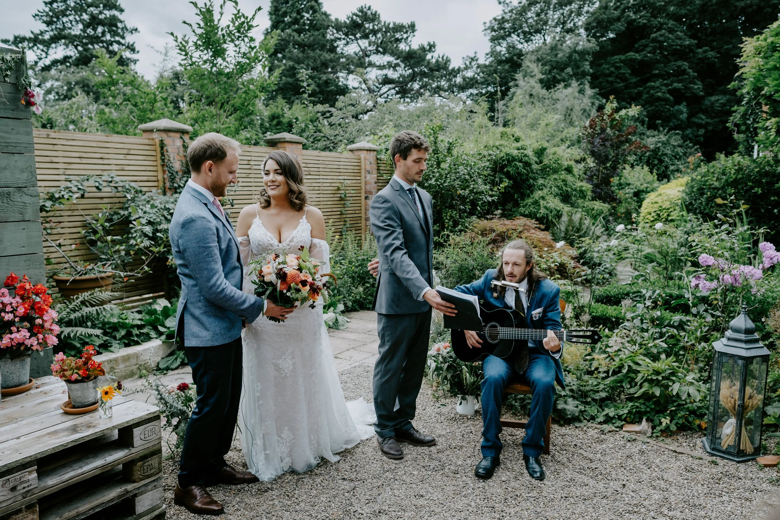 bride and groom intimate ceremony with a friend singing at the Coach House in Derby