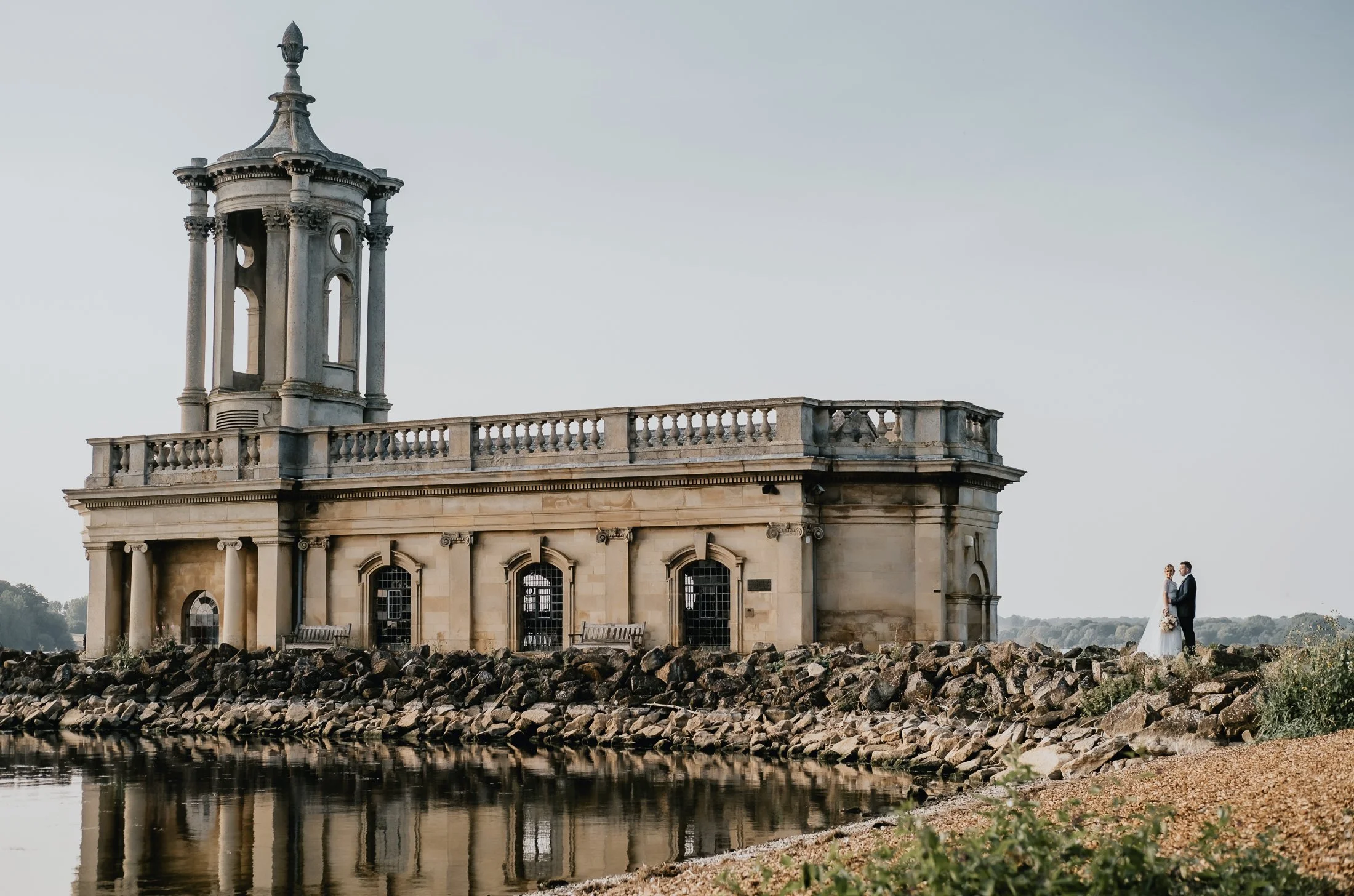 A bride and groom for a Normanton Church wedding at Rutland Water with scenic lakeside views and natural documentary photography